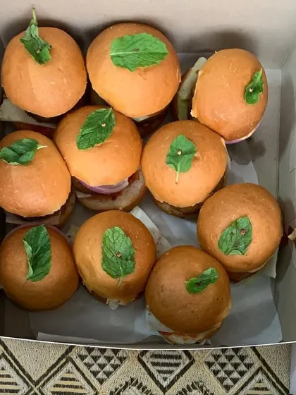 A close-up of the mini veggie burgers in a box.