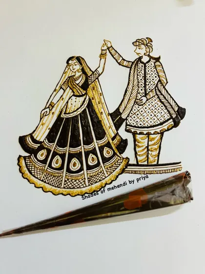 A close-up of a dancing couple sketch, with one of my henna cones. This is where the magic begins.