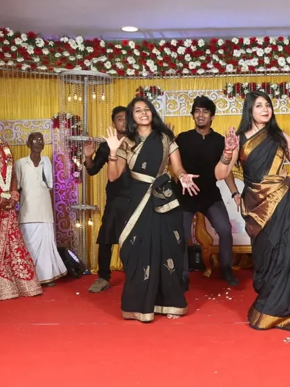 The bride and groom watch with delight as their school friends perform for them. Surprise performances from loved ones are always a highlight of the evening.