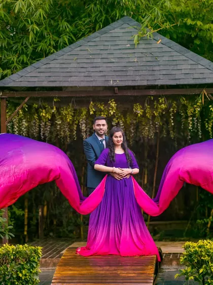 The vibrant purple and pink gown creates a stunning visual effect in this garden setting. I love using flowing fabrics to add movement and a touch of magic to my photos.
