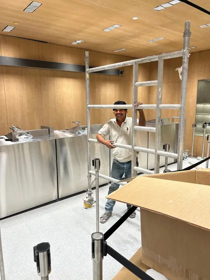 A member of our team working on the scaffolding during the fit-out of the Apple store. The interior features custom stainless steel fixtures and wood paneling, all imported and installed with the pin-point precision required by the client.