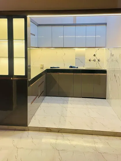 A wide view of a completed kitchen, seen from the dining area. The open-frame design makes the space feel integrated with the rest of the home.