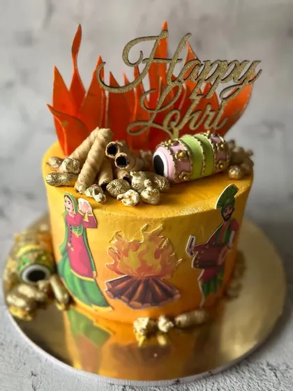 This Lohri cake is full of festive details. It's decorated with illustrations of bhangra dancers, a bonfire, and edible dhols, capturing the joyful spirit of the harvest festival.
