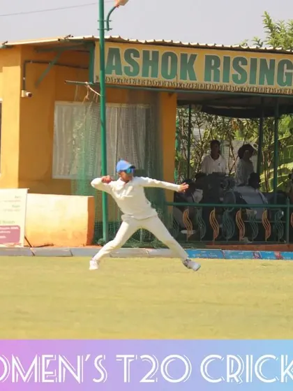 A spectacular fielding effort near the boundary, with the pavilion in the background.
