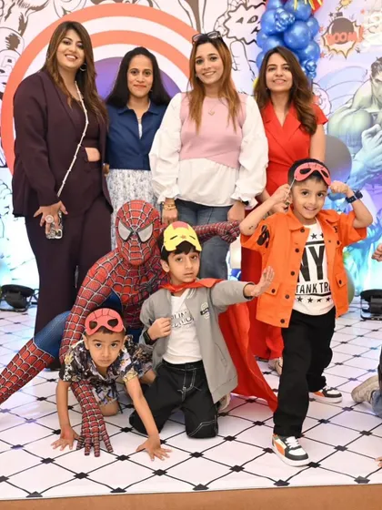 Spider-Man posing with the kids. Having their favorite hero at the party is a dream come true for them.