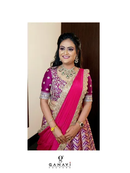 A smiling portrait of Kusuma, looking radiant in her festive ensemble. Her diamond jewelry and the rich colors of her outfit make for a stunning combination.