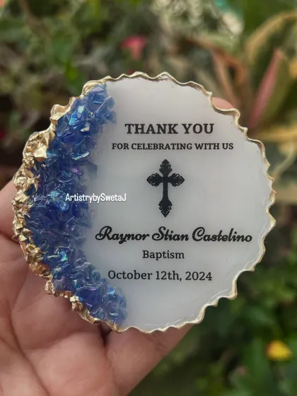 A close-up of the baptism magnet, showcasing the iridescent blue crystals and crisp, clear text.