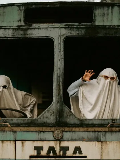A funny shot of the ghost couple "driving" the abandoned bus.