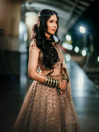 A stunning night-time portrait. The makeup is designed to look flawless and radiant, even in low light, creating a look of pure grace.