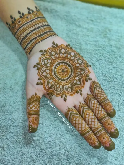 A designer mandala that is both intricate and elegant. The layers of petals and patterns create a beautiful focal point on the back of the hand.