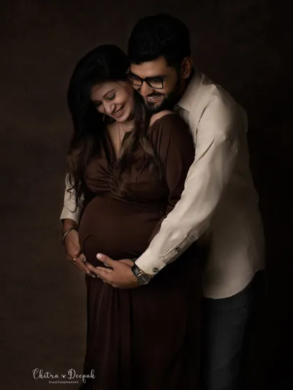 An intimate and candid moment captured in our studio. The genuine smiles and gentle embrace make this photo feel incredibly special.