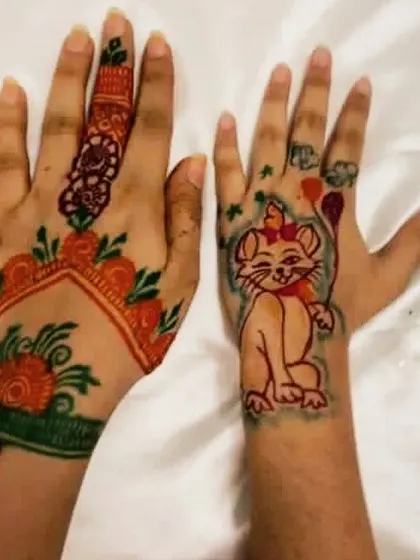 I also offer safe, temporary colored henna tattoos. This is a great option for kids, anyone with allergies to natural henna, or for those who want a playful pop of color. Here you can see a fun cat design next to a more traditional colored floral pattern.