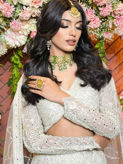 A vision in white. This modern bridal look features soft, shimmery eye makeup and a natural, glowing base, perfect for a chic and elegant bride.