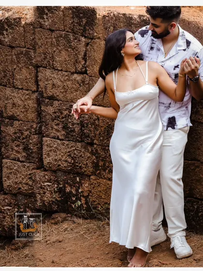 A candid and fun moment from a pre-wedding shoot near a historic Goan site.