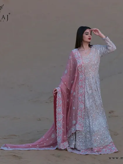 A full view of the magnificent peach with coral peach Indo-Western Gown, a classic creation reflecting vibes of royalty.