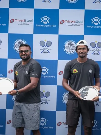 Mohit and Oges receiving their doubles winner's plates from the sponsors.