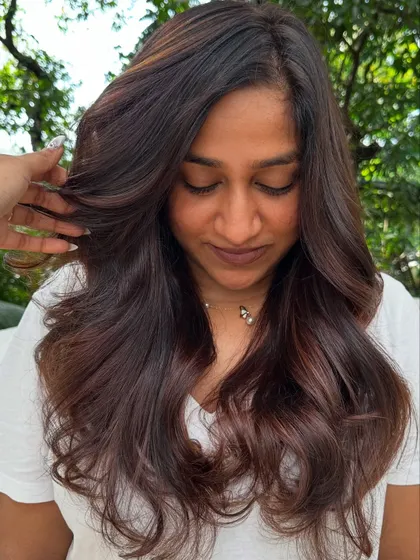 A portrait of the client with her new 'Chocolate Mahogany Brown' hair.