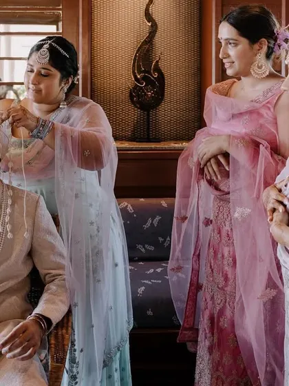 The groom's sisters perform the Sehra Bandi ritual, a beautiful and significant tradition in Punjabi weddings. I capture these family-centric moments with care.