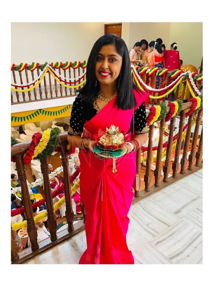 Ready for the ceremony, this client looks lovely holding a traditional offering while wearing her custom-designed velvet blouse.