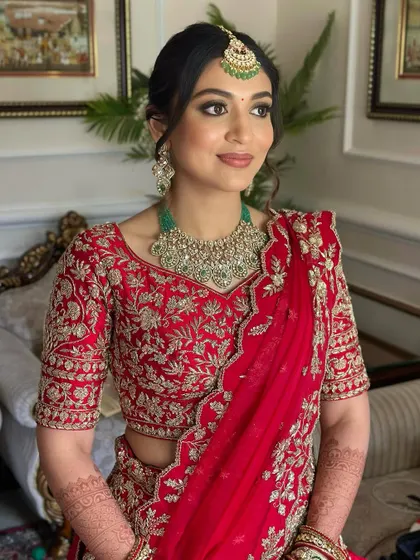 A seated portrait showing the intricate details of her outfit and the soft, radiant makeup. She looks calm, confident, and ready for her big day.