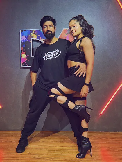 A posed shot with a partner, hinting at a sensual, commercial heels choreography style. I enjoy exploring different genres of dance.