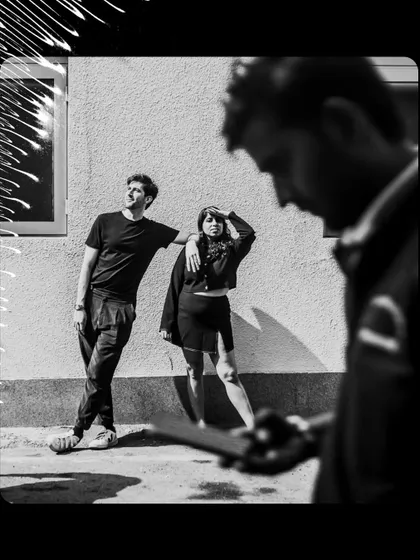 A behind the scenes perspective of a couple's shoot. This black and white image shows the creative process and the relaxed environment I create.