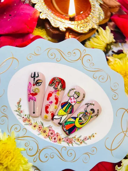 Another view of the hand-painted Navratri nail art set, displayed beautifully with a traditional diya, capturing the festive spirit.