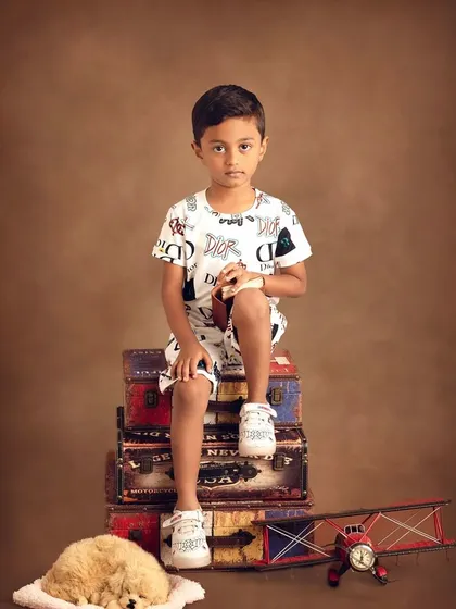A serious explorer, ready for his journey. The props, like the toy plane, help tell a story of adventure and discovery.