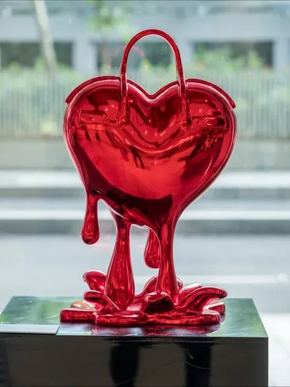 We present 'Melting Affection,' a sculpture that transforms a luxury handbag into a melting, heart-shaped form. It blurs the line between desire, love, and material obsession, asking whether our most cherished treasures are symbols of love, status, or both.