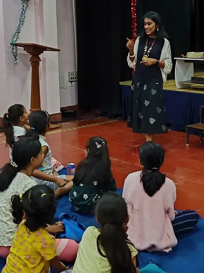 A guest storyteller engaging with the children. We often invite other artists to share their unique styles and stories with our audience.
