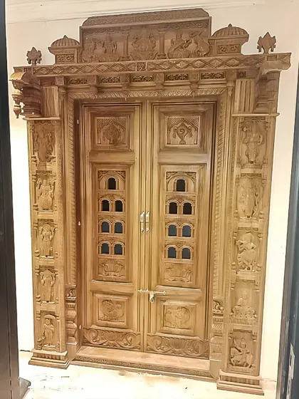 A masterpiece of traditional woodwork, this intricately carved pooja room door is a work of art. It brings a sense of heritage and divinity to the home's entrance.
