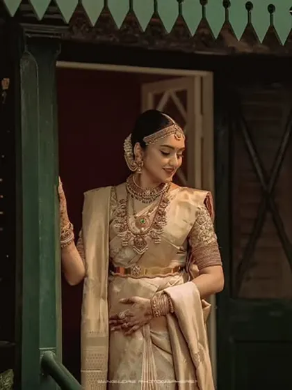 The bride stands at the doorway, a picture of grace and anticipation. This portrait captures the feeling of stepping into a new life.