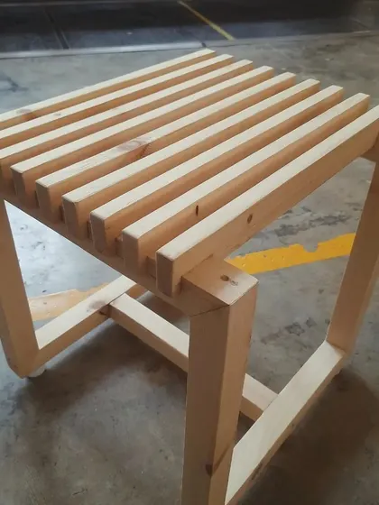 A modern slatted stool with a continuous frame design, crafted by students in our conventional woodworking batch as their final project.