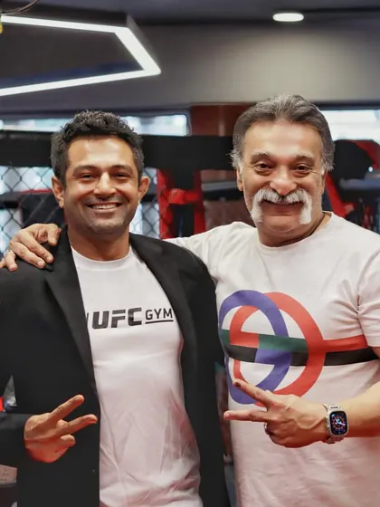 With a fellow MMA enthusiast at the UFC Gym event. The community is growing.