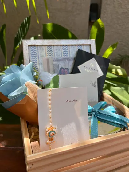 A close-up of the adorable Rakhi and other elements in the sister hamper, perfect for celebrating sisterhood.