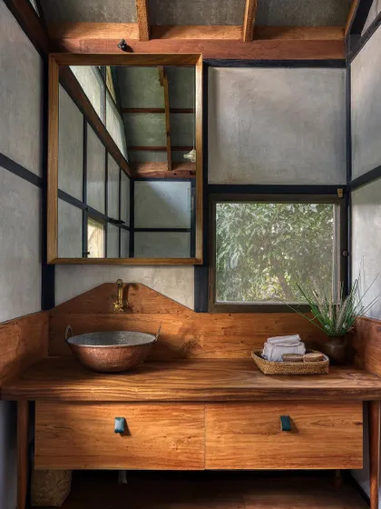 The bathroom vanity combines a custom wooden counter with a hammered copper sink. We use natural and handcrafted elements throughout the home to create a cohesive and authentic living experience.