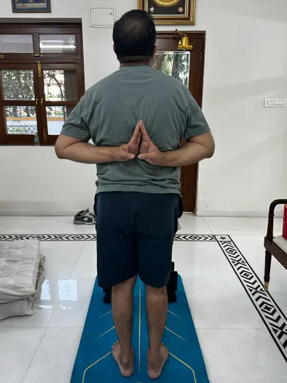 This client, who has been dealing with Gout for 15 years, is now able to do a reverse prayer pose. This demonstrates a significant improvement in his shoulder and wrist mobility.