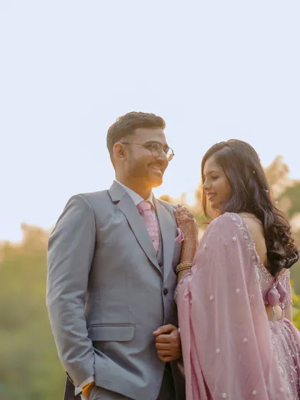 A sun-kissed portrait of the couple sharing a quiet moment at their engagement. The golden light and their gentle interaction create a warm and romantic photo.
