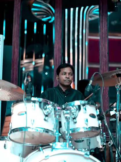 Our drummer, focused and in the zone, providing the solid backbone for our music.