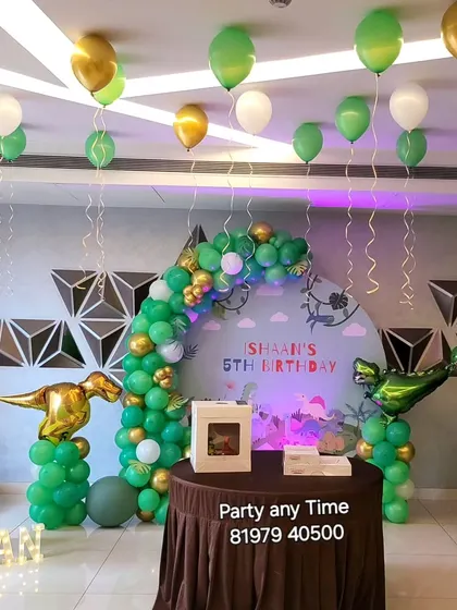 The full dinosaur party scene, including helium balloons floating on the ceiling.