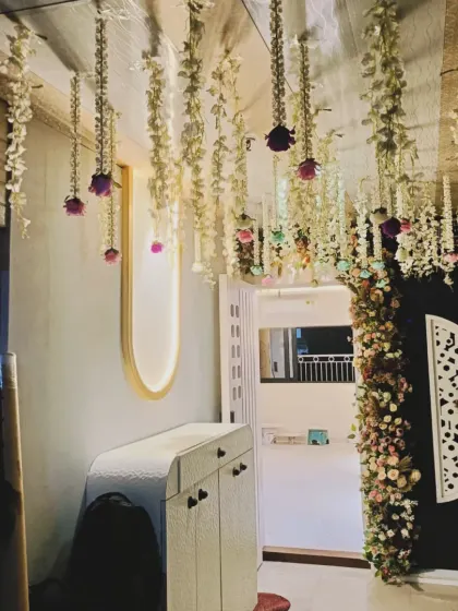 A simple way to decorate a home entrance. I used strings of jasmine and rose flowers hanging from the ceiling to welcome guests into the celebration.