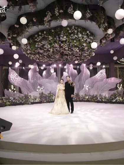 A stage set for forever. For this elegant engagement, I designed a dreamy, romantic backdrop with ethereal fabrics and a breathtaking floral canopy. It’s all about creating a magical space where your love story can take center stage.