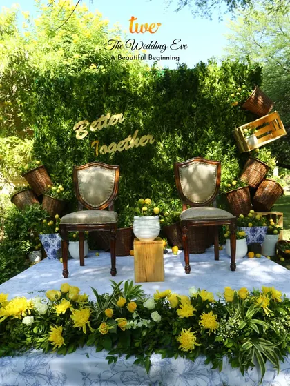 A "Better Together" seating area for the couple, set against a green wall and adorned with lemons and yellow flowers for a fresh, Tuscan feel.
