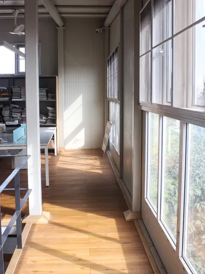 Sunlight streams into our upper-level workspace through large windows. We prioritized natural light in our own studio design to create a bright and healthy environment for our architects.