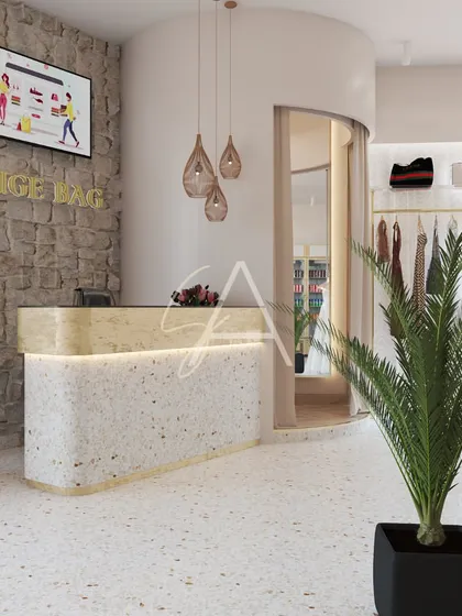 The cash and reception counter for the 'Beige Bag' boutique. We combined a terrazzo base with a stone accent wall and delicate pendant lights to create a welcoming and on-brand checkout area.