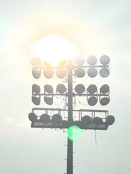 A close-up of one of our floodlight towers against the sun. These lights are strategically placed to eliminate shadows and provide consistent, bright illumination for night matches.