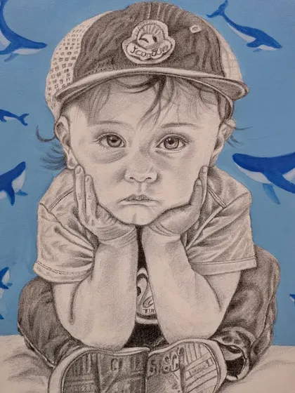 The completed ballpoint pen portrait of a child, with the addition of blue whale motifs in the background, creating a unique and imaginative piece.