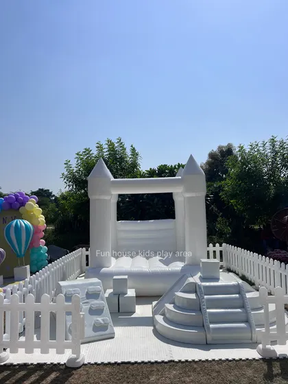 A frontal shot of our white bouncy castle, showing its classic castle design that sparks the imagination of every child.