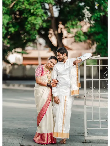 A classic post-wedding portrait of a couple, the bride resting her head on her husband's shoulder.