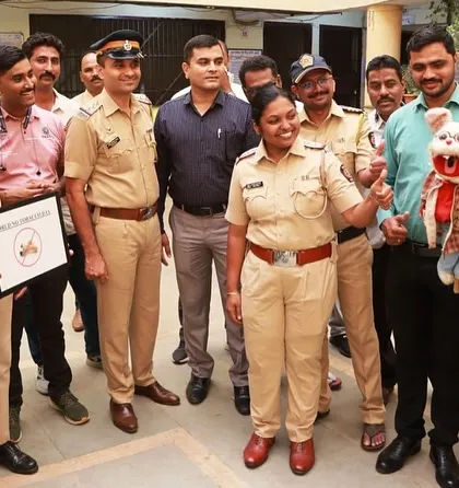 A female police officer interacts with my puppet during the anti-tobacco campaign. Using puppets helps break the ice and makes the message more memorable.